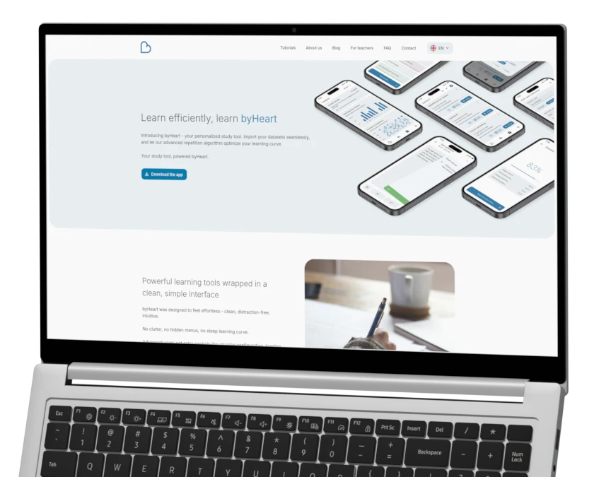 A realistic render of an open laptop displaying the byHeart website